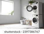 Interior of modern laundry room with washing machines and grey bench