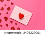 Composition with envelope and red hearts on pink background. Valentine's Day celebration