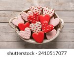 Basket with tasty heart shaped cookies on grey wooden background. Valentine's Day celebration