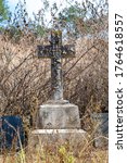 Small photo of Pilgrims Rest, Mpumalanga, South Africa, 06 26 2020 Historic Cemetery in old gold mine village Alice Packman fell asleep 1895 cross on tomb with overgrown grave out of focus with grain