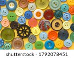 Small photo of multifarious buttons for clothes on yellow . High quality photo