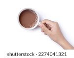 Hand hold cup of hot chocolate cocoa drink isolated on white background. Top view. Flat lay. Clipping path. 
