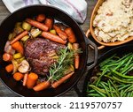 Small photo of Pot roast in a cast iron dutch oven, green beans and mushed potato.