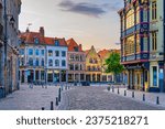 Vieux Lille old town quarter with empty narrow cobblestone street, paving stone square with old colorful buildings in historical city centre, French Flanders, Hauts-de-France Region, Northern France