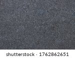 Dark grey granite background used for kitchen worktop, table, window sill, fence. Black and white igneous rock stones texture. Text sign advertising design mockup. Architecture detail natural backdrop
