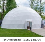 White mobile dome design. Outside spherical glamping dome. Hemispherical structure lattice shell geodesic polyhedron. Camping house hotel party tent. Folk accommodation park outdoor leisure recreation