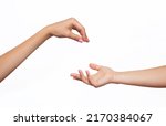 Small photo of Female hand makes a gesture like handing some kind of hanging object as keys to the other outstretched hand isolated on a white background. Mockup with empty copy space for a intended object. Handover