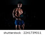 Bodybuilder posing on black background. Muscular and athletic young man doing bodybuilding posing. Gym motivation. Bodybuilder man.