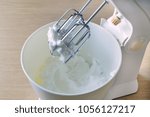 Bowl with wipped cream and electric mixer