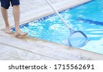 Man Cleaning A Swimming Pool In ...