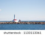 A Lighthouse Off The Coast Of...