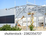 Small photo of Complex large volume steel frame structure assembly using self propelled scissor lift and articulating boom lift platforms