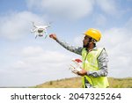 Drone Pilot safely receiving drone using remote controller - Concept of return to home, aerial survey using UAV technology.