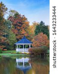 Small photo of Gazebo and water reflection at Broyhill Park in autumn in Blowing Rock, North Carolina.