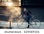 A young stylish businessman going to work by bike. 