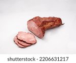 Small photo of Gammon, smoked ham - in one piece and sliced, isolated on a white background. Polish cold cuts, a packshot photo.
