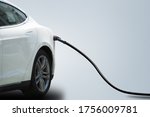 Charging electric car isolated on grey background. Copy space