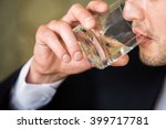 man drinking alcohol from a glass