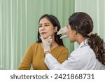 Small photo of Doctor giving female patient medical injection in temporal. Atmosphere at cosmetic surgery department in hospital clinic.
