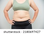 Small photo of Beautiful fat woman wearing exercise clothes . Want to lose weight, suck fat from the body.