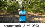 Small photo of Portrait of African American volunteer man enjoy charitable social work outdoor in the mangrove planting project