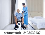Hospice nurse is helping Caucasian man in the wheelchair to exercising muscle strength in the pension retirement center for home care rehabilitation and post treatment recovery process