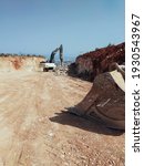 Small photo of February 25, 2021 - Antalya, Turkey : HIDROMEK HMK 370 excavator doing work on the construction of a new road on the hill with background view to the city and mountains