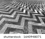 Cement floor decorated with marble with a zigzag pattern.