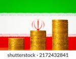 Small photo of Upgoing graph made of coins stacked in front of Iran flag. Concept of financial development of Iran
