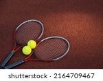 Top view tennis scene with balls, racquets on hard tennis court surface