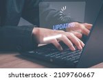 Small photo of Installing software update process, operating system upgrade concept. Hand using laptop with Installing app patch or app new version updating progress bar on virtual screen.