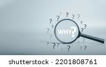 Small photo of Magnifying focuses on "WHY ?"question text and question mark be around. Business answer and analysis, problem ask, interrogation, research information concept. with copy space on grey background.