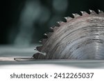 Circular saw. Detail of worn circular saw teeth. Saw after cutting wood. Wear of the working tool. Dull and dirty cutting tool, saw blade. Blunt instrument, Sharp instrument.