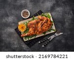 Small photo of Grilled chicken. A half baked chicken with lemon and spices baked in the oven. Delicious juicy chicken. Grilled poultry.