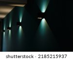 Modern wall lamps is lighting on the dark green wall. backlit, night decorative lamp