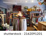 Small photo of Interior Of Charity Shop Or Thrift Store Selling Used And Sustainable Clothing And Household Goods