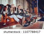 Group of friends enjoys in lunapark. Amusement park concept.