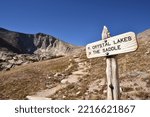Small photo of National Park trail sign placed where trails diverge in alpine tundra - Rocky Mountain National Park, Colorado, USA
