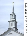 Wooden white steeple over old...
