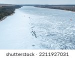 Small photo of Aerial view of many fishermen on ice, winter fishing, dangerous fishing on thin ice, winter