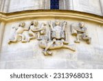 Small photo of Schongrabern, Lower Austria, Austria - 03 18 2023: The Romanesque relief on the church shows the biblical story of Cain and Abel