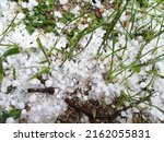 Small photo of Koszalin, Poland - May 30, 2022: Hail, precipitation before the beginning of summer. Hail balls on a green lawn.