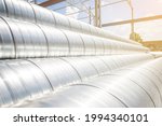 Ventilation pipe warehouse. Steel pipes, parts for the construction of air ducts for an industrial air conditioning system in a warehouse. Industrial airway ventilation equipment and piping systems.