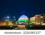 Small photo of Kigali, Rwanda - August 19 2022: Kigali Convention Centre lit up in the colors of the Rwandan flag. The facility, designed after the inside of a king's palace, is able to host a variety of events