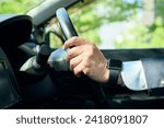 An office worker in his 50s gripping the steering wheel