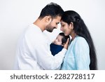 Portrait of Indian parents with newborn baby, Young asian couple holding little baby in hand. Beautiful family. Parenthood.