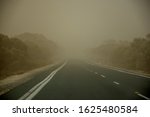 A dust storm on the road near Mildura, Australia. Dust particles in the air cause low visibility