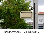 Small photo of white blank sign hangup on black pole