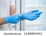 Doctor wearing blue nitrile gloves (select focus)