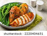 Oven baked boneless chicken breast made with paprika and parsley,  green beans. Healthy eating concept.